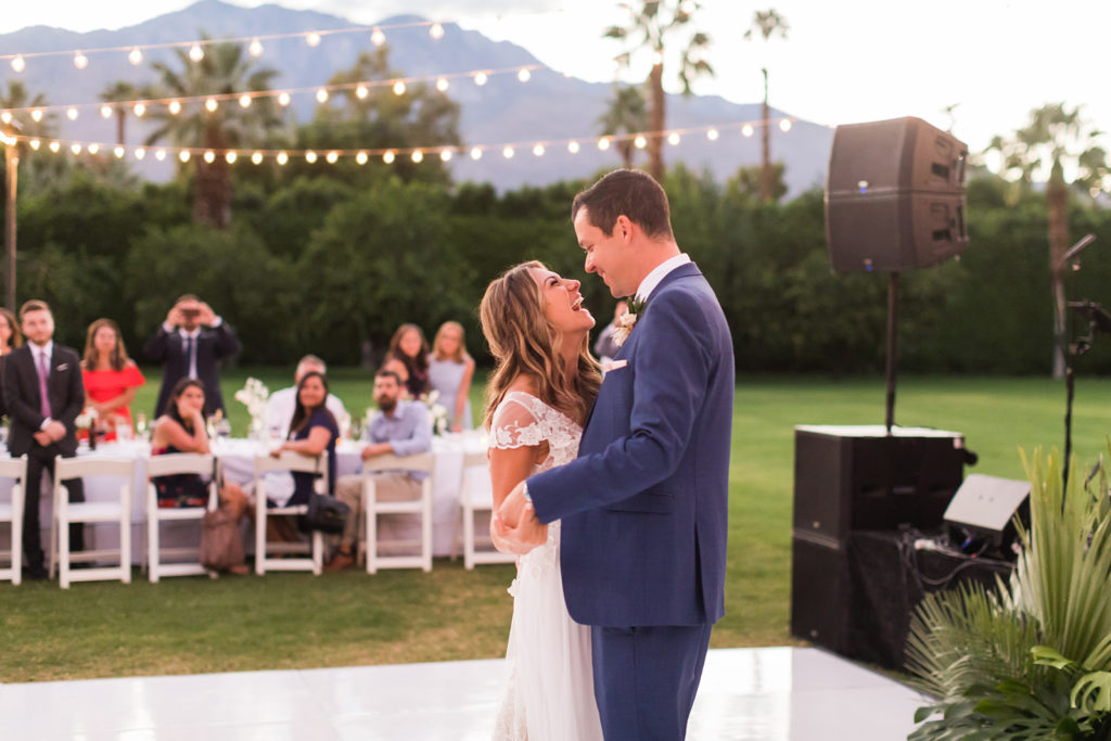 bride and groom first dance under twinkling lights outdoor
